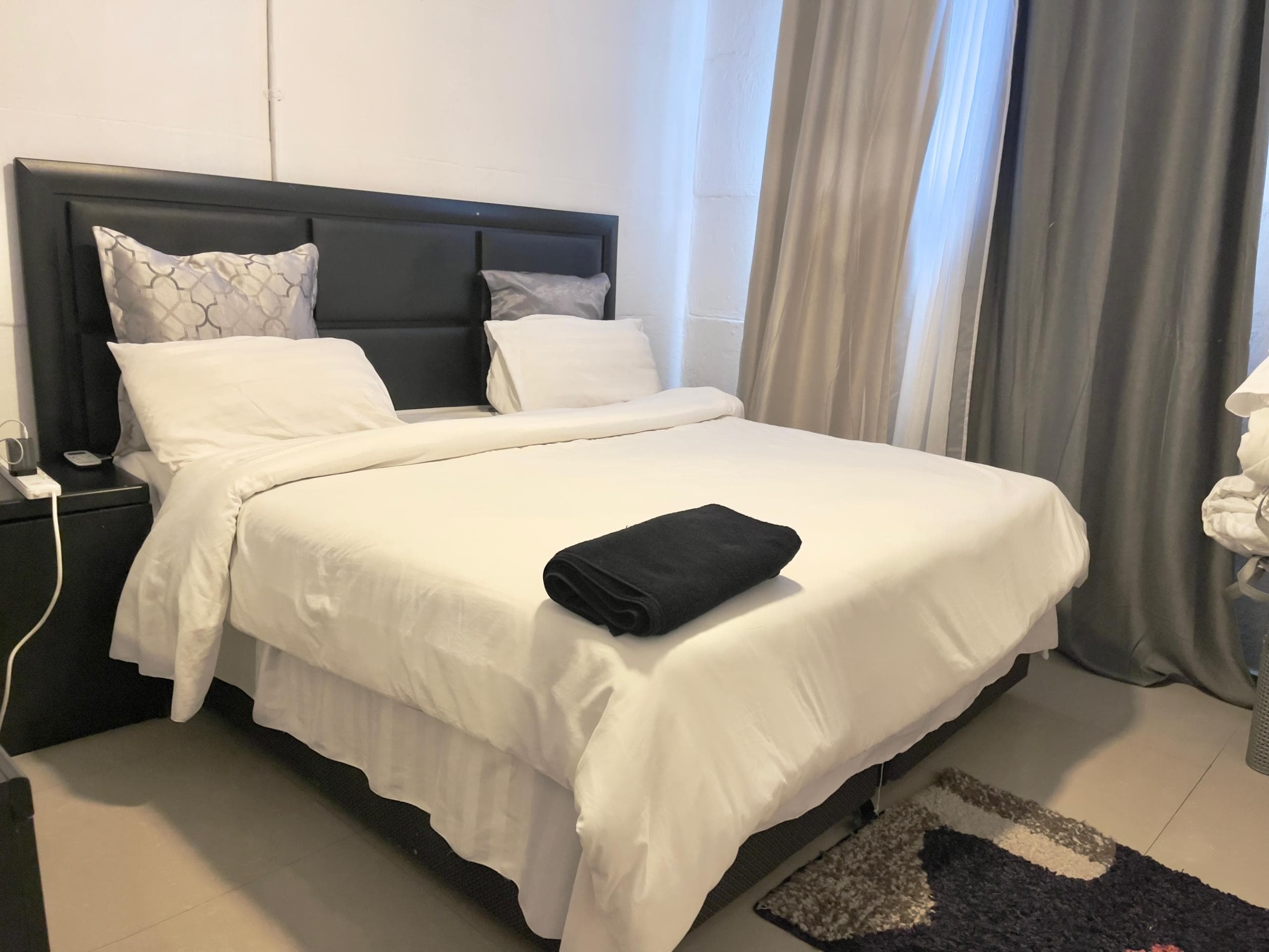 Majestic Haven — Bedroom with white linens and natural light at Majestic Haven
