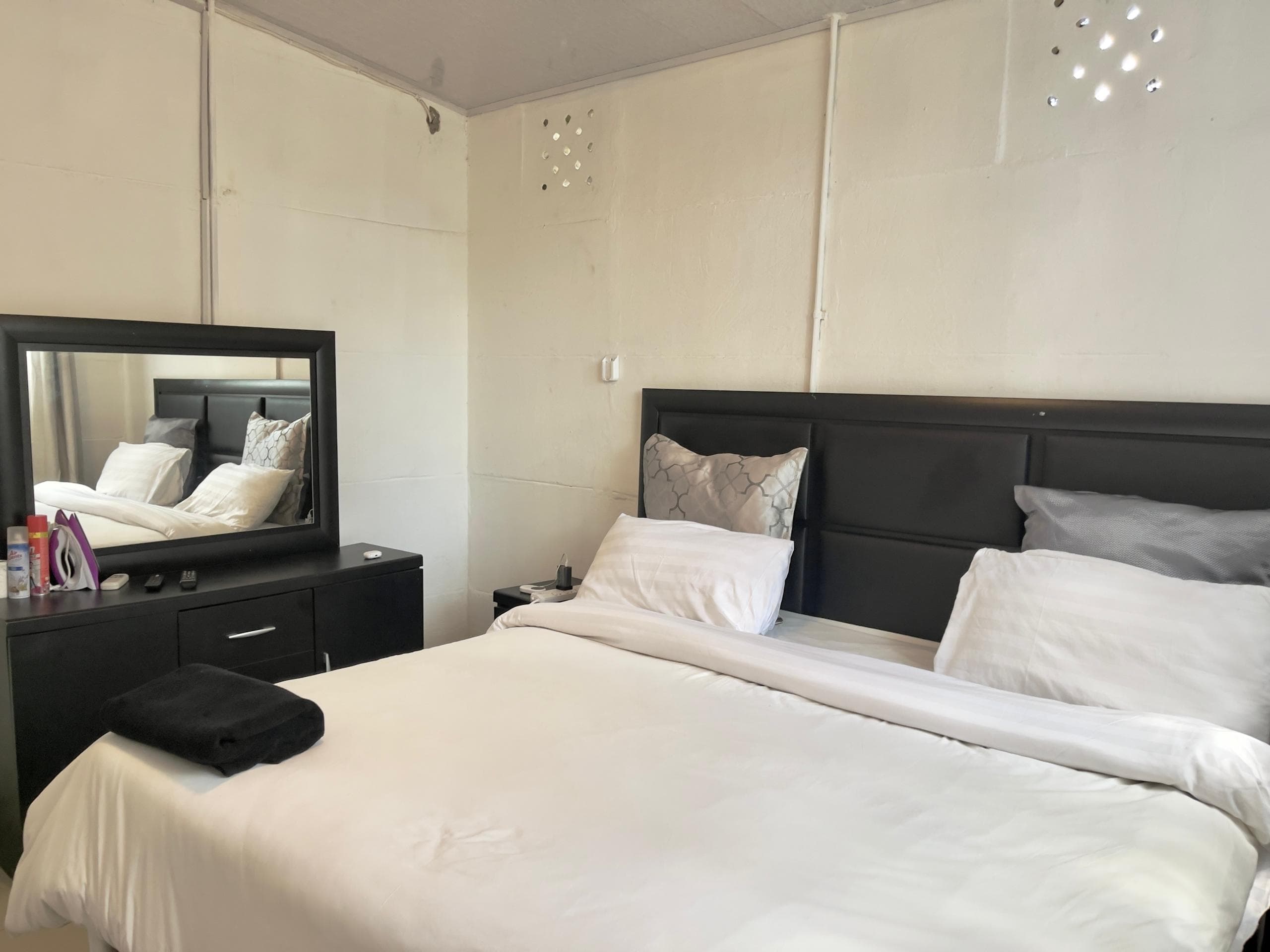 Majestic Haven — Bedroom and dresser at the 1-bedroom apartment